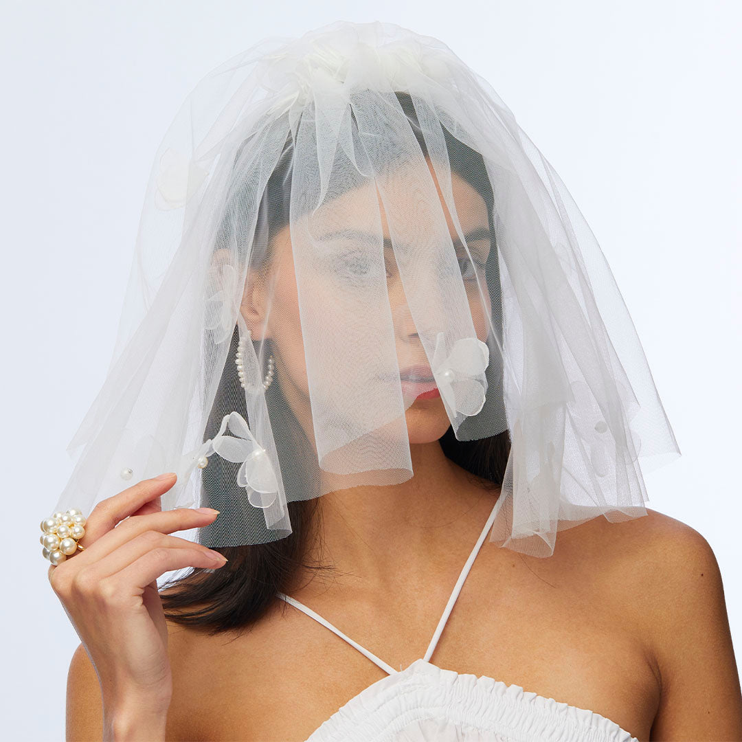 model wearing Lele Sadoughi Ivory Poppy Floral veil